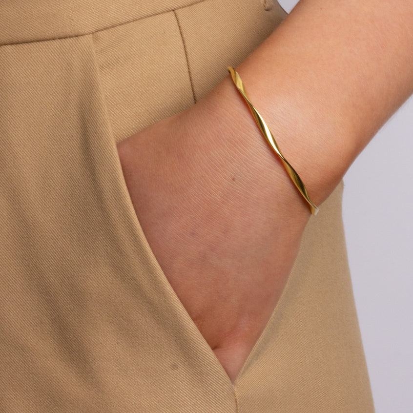 With a twist bangle armbånd i guld